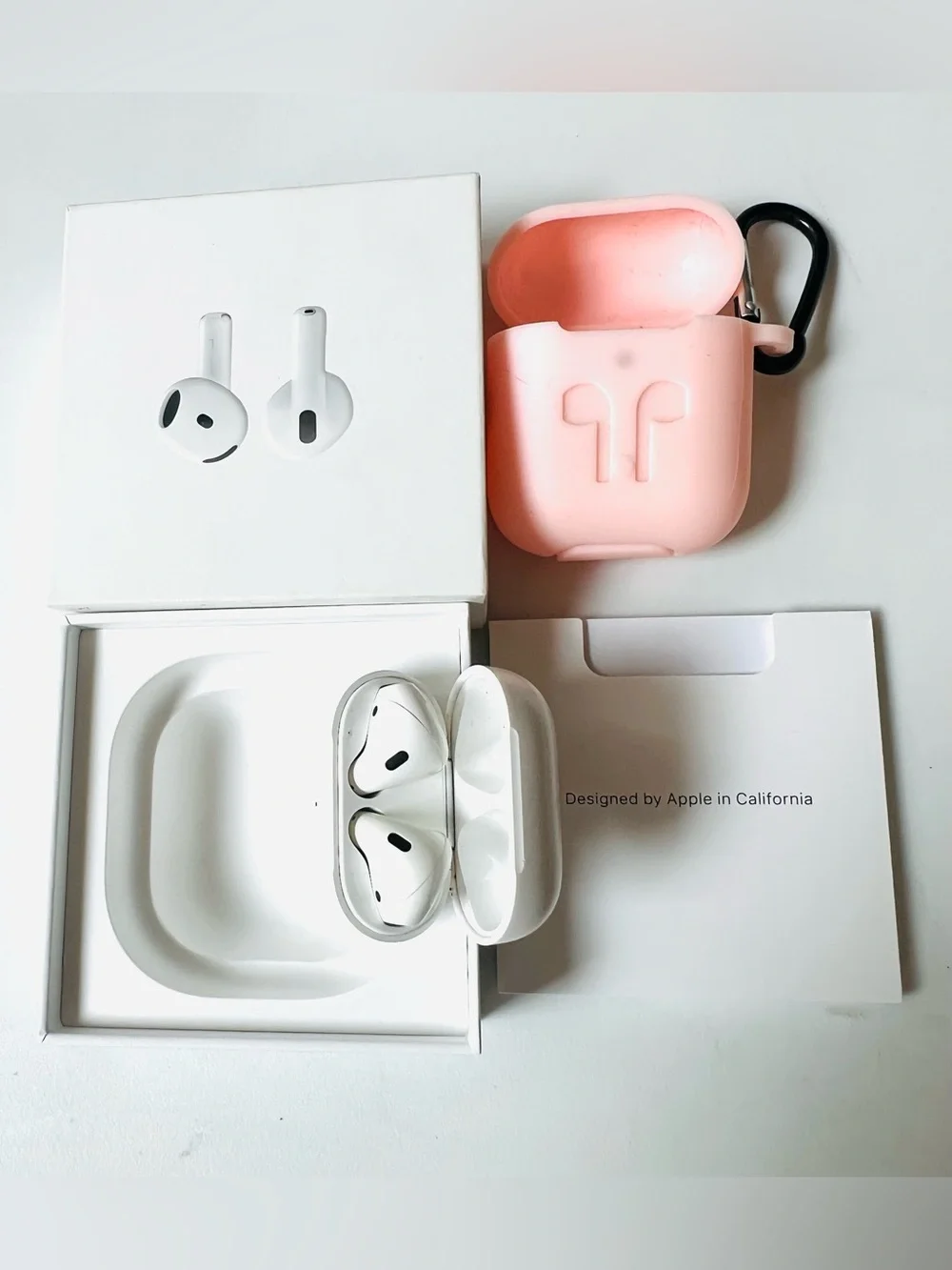 Apple AirPods with Pink Silicone Case and Carabiner in Working Conditions Like N